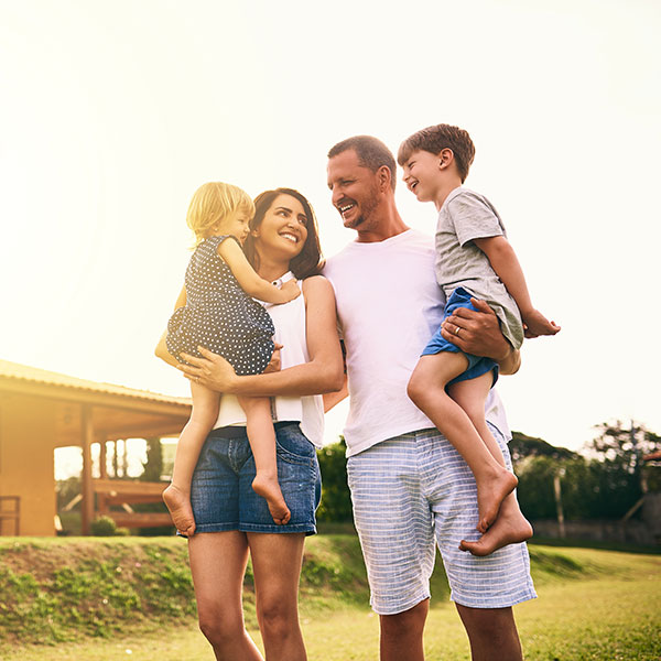 A family poses together in front of their home in Scottsdale, AZ
