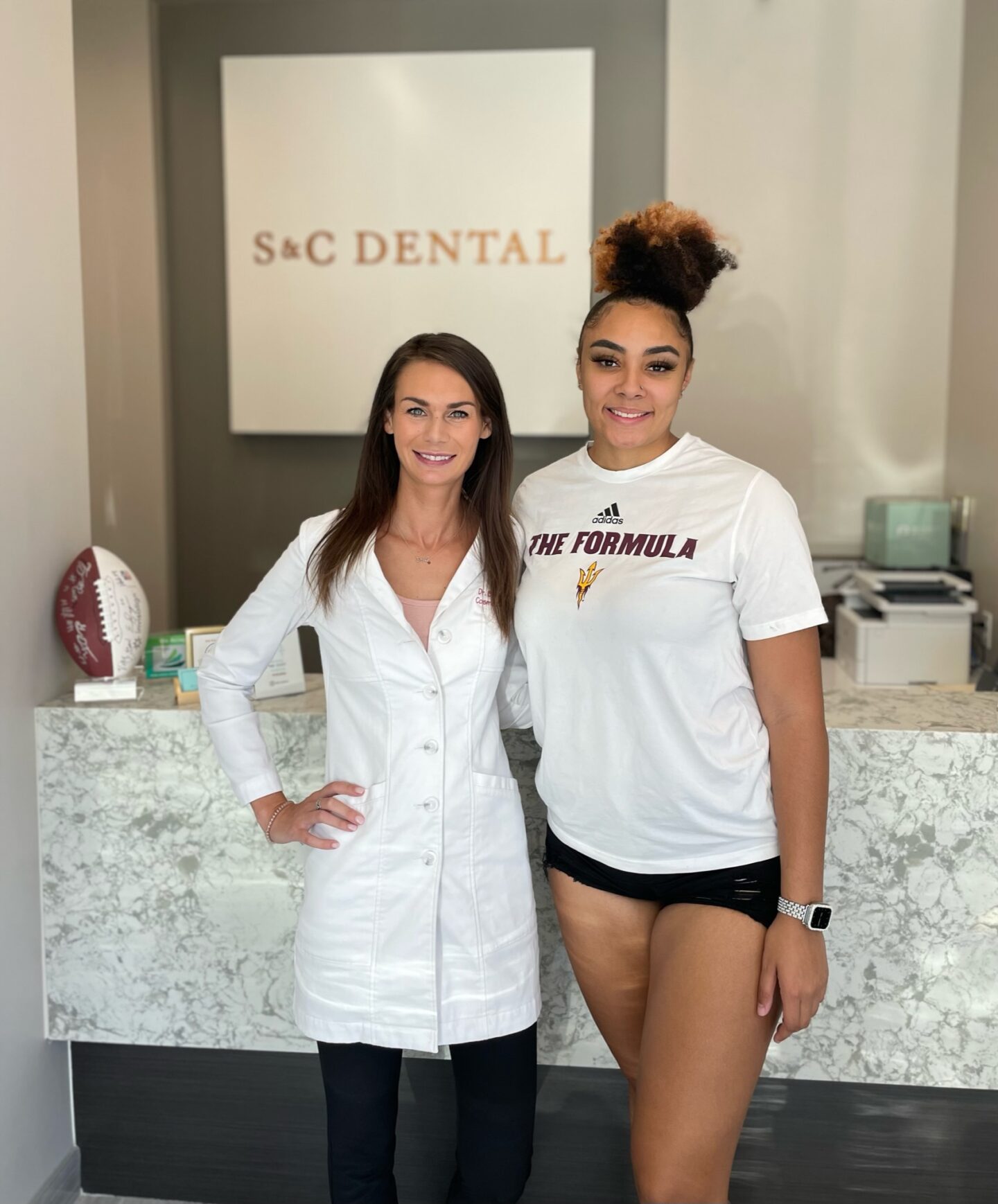 Dr. Bri next to patient smiling with whitened teeth Scottsdale AZ