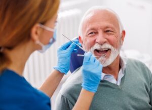 The Old Man Getting His Dental Implants Checked at S&C dental in Scottsdale AZ.