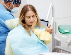  A Woman in Severing with teeth Pain gets a Treatment from the Dentist.